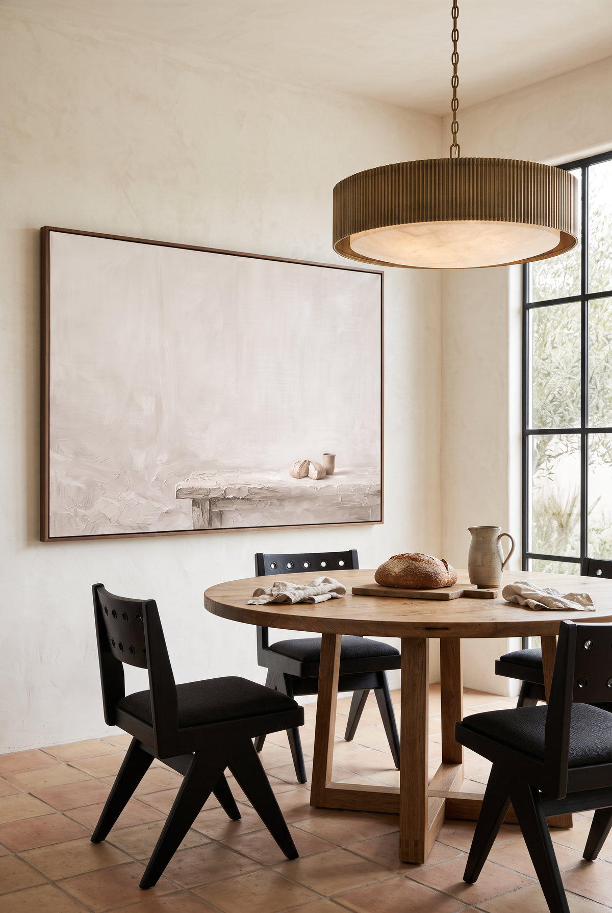 Do This in Remembrance framed canvas beside a round oak table in a terracotta-floored breakfast room