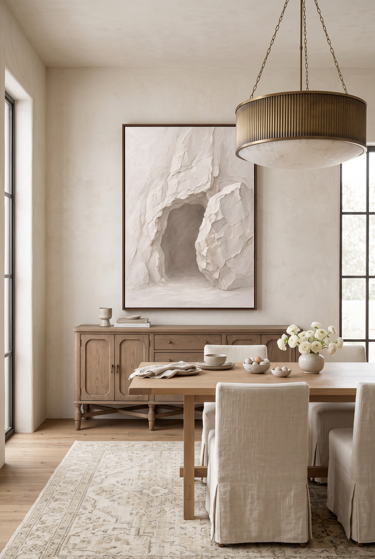 He Is Risen framed canvas above an oak sideboard in a dining room set for Easter brunch