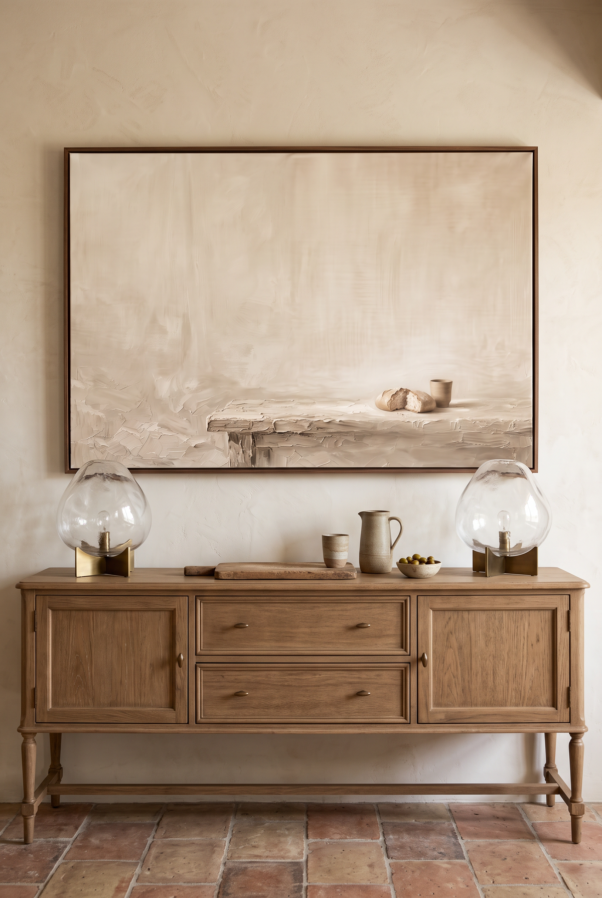Do This in Remembrance framed canvas above an oak sideboard styled with bread, a cup and glass lamps